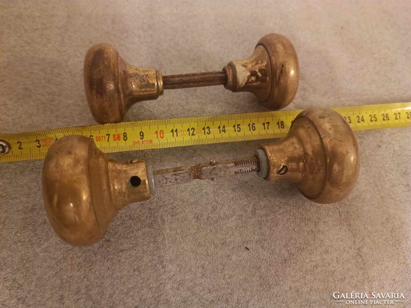 A pair of art deco brass doorknobs