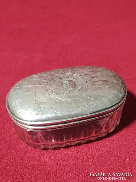 Polished glass container with silver lid pipe holder