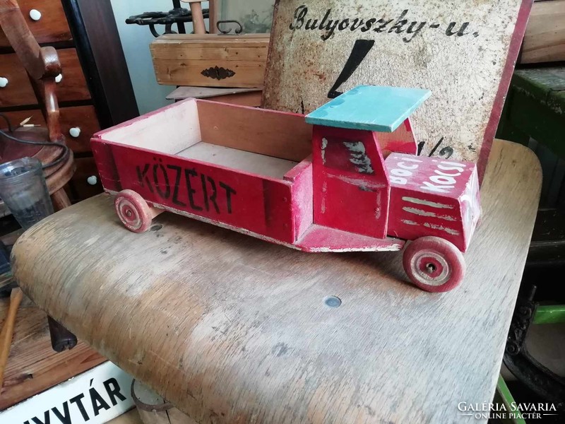 Wooden van from the 1960s with a public sign on the side and unique decoration, retro toy
