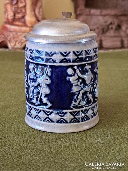 Mini blue patterned ceramic beer mug with opening cap on the top, the marking on the bottom is blurred