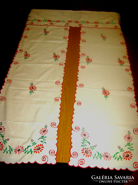 3-part embroidered drapery towards and next to the door