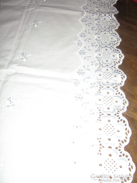 Beautiful elegant white madeira lace tablecloth on the edge
