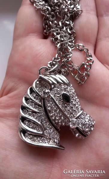 Diamond-cut silver-plated chain with rhinestone zebra pendant.