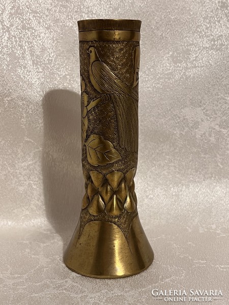 A vase made of brass cartridges with a bird forest in relief is a significant unique handicraft ornament