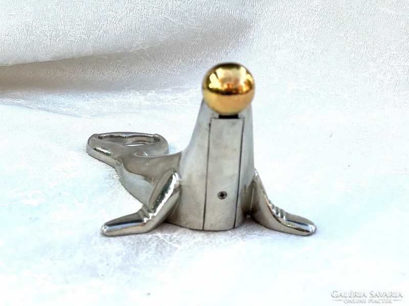 A seal playing with a ball is a special lighter and bottle opener
