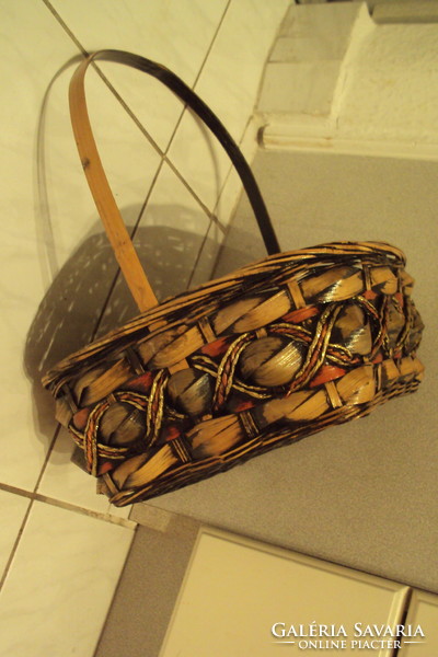 Rectangular storage basket made of brown-gold cane, lacquered with handles.