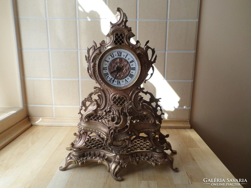Old copper decorative Rococo fireplace clock with mechanical clock mechanism