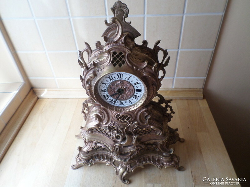 Old copper decorative Rococo fireplace clock with mechanical clock mechanism