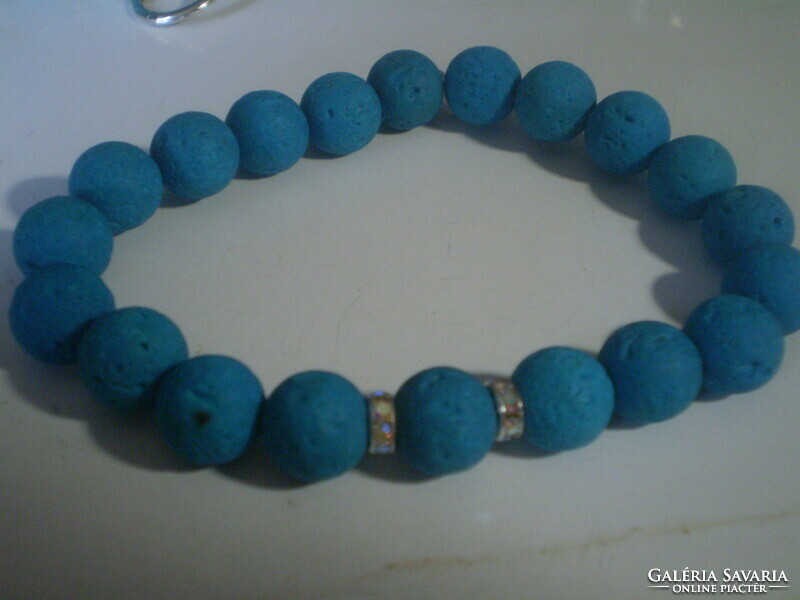 For half, a blue painted bracelet with real lava stones
