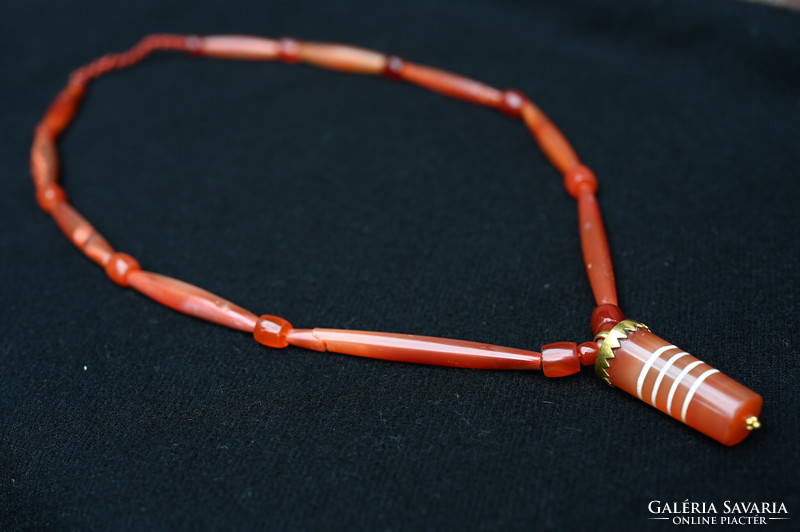 A 2,000-year-old pendant made during the Pyu Empire, a necklace of Burmese carnelian pearls
