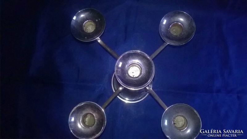 Silver-colored, five-pronged metal candle holder