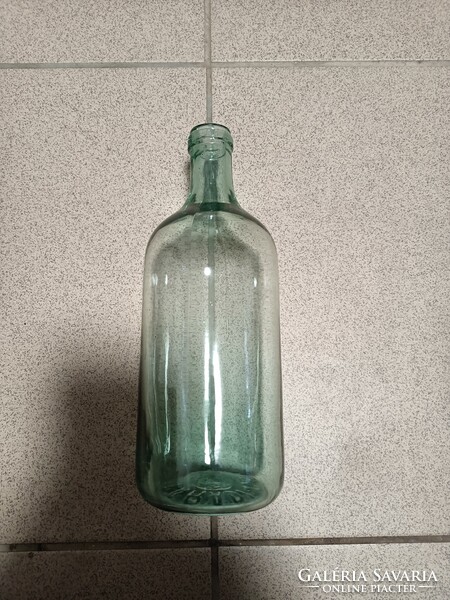 1 bottle of parade ccevice water with a green tint.