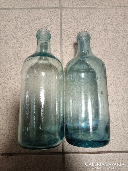 2 ccevice water bottles with a bluish tint.