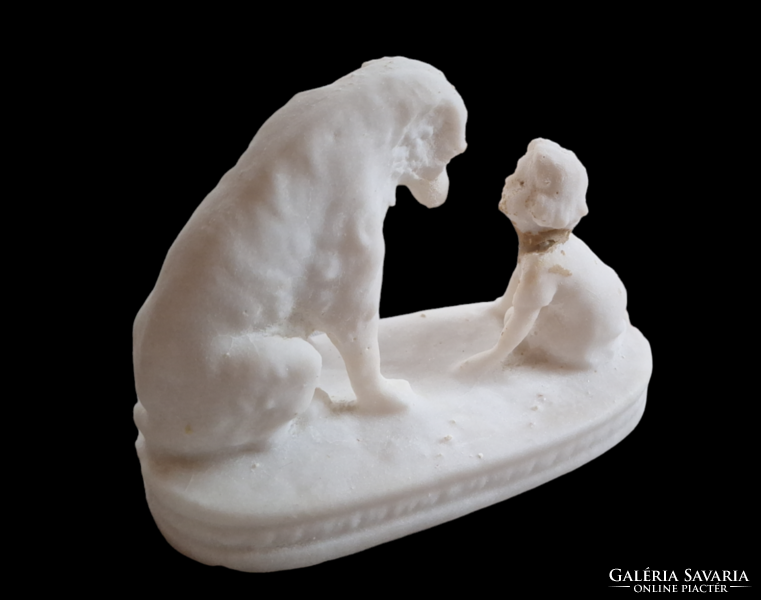 Stone statue of a dog with a child