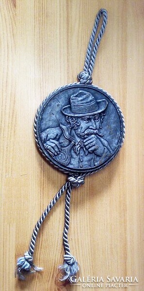 Cast wax cord wall hanging with an old man in a hat