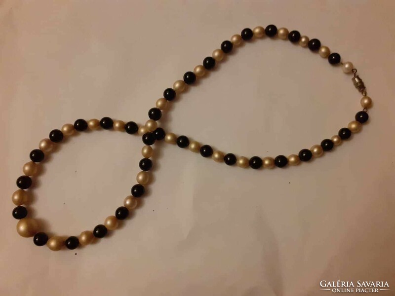 Old string of beads combining black glass and tekla beads