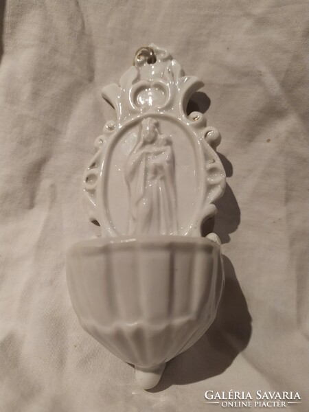 Old wall-mounted porcelain holy water container