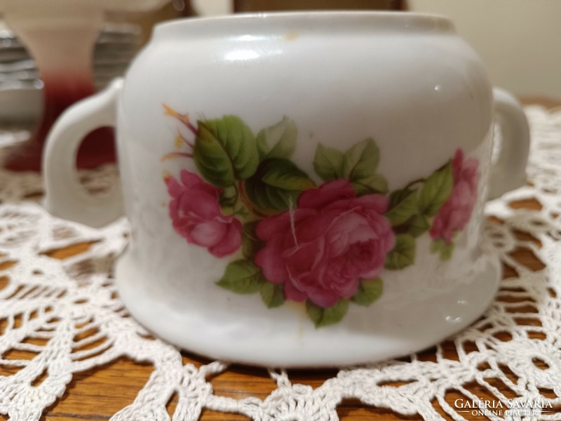 Antique coma cup with a bouquet of roses