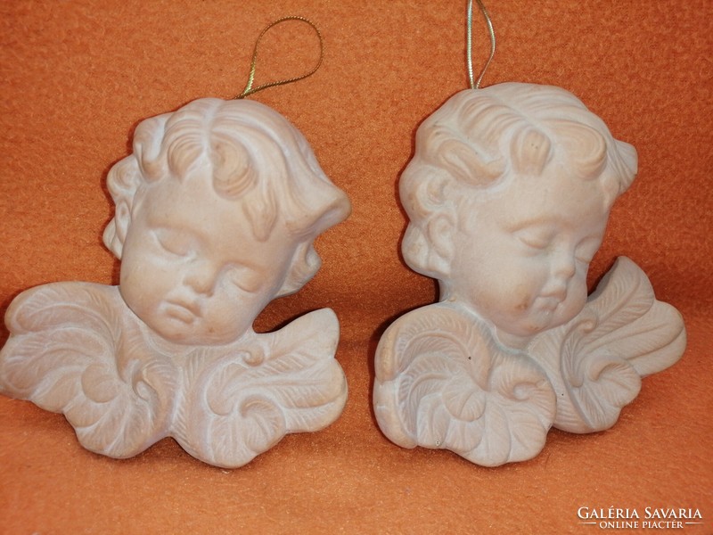 2 natural-colored, ceramic, wall-hanging angels.