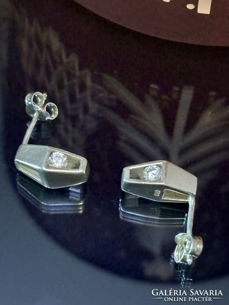 A pair of silver earrings in art-deco style with zirconia stones