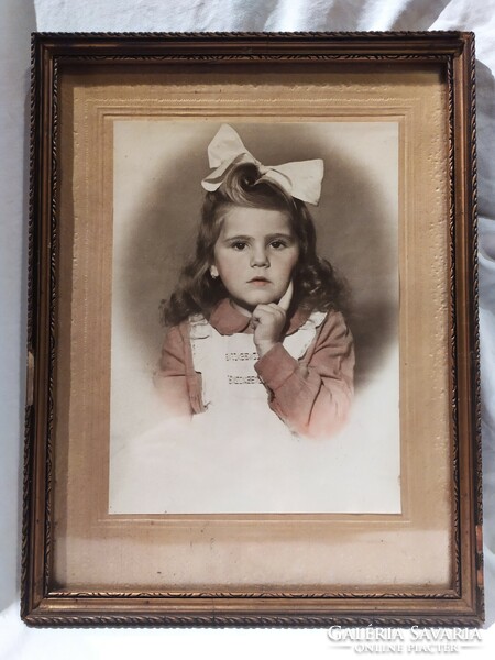 Antique child portrait in a large colored photograph frame