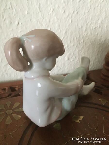 Little girl dressing up - old Aquincum porcelain figure