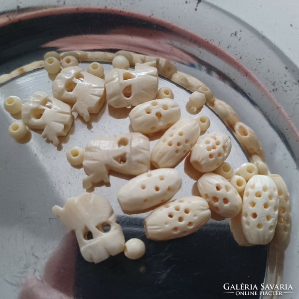 Exotic bone (fang) beads, 26 pieces