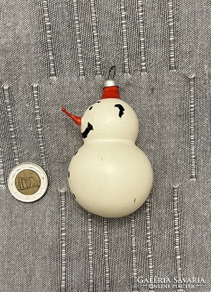 Old retro snowman with glass Christmas tree decoration