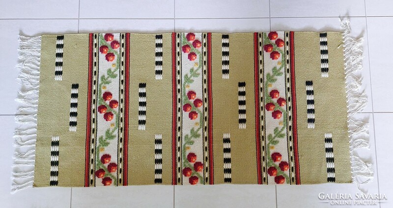 Retro carpet with fringes, small runners on an olive green background with flowers