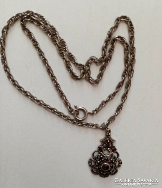 Old silver-plated twisted necklace with a pendant studded with openwork pattern red stones