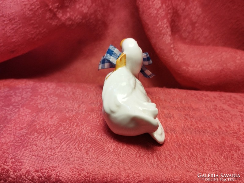Miniature porcelain duck in an interesting pose