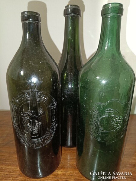 Three patina bottles of Budafoki Wine City.