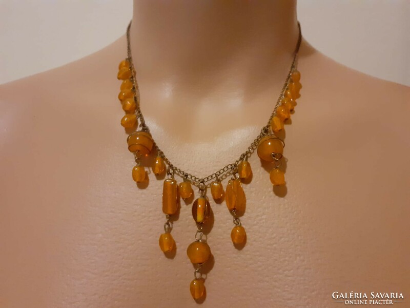 Showy necklace combined with glass beads