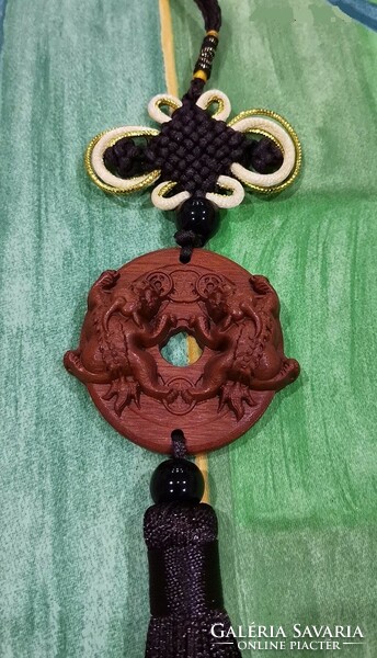 Real room. Feng shui rosewood pendant, amulet, financial security