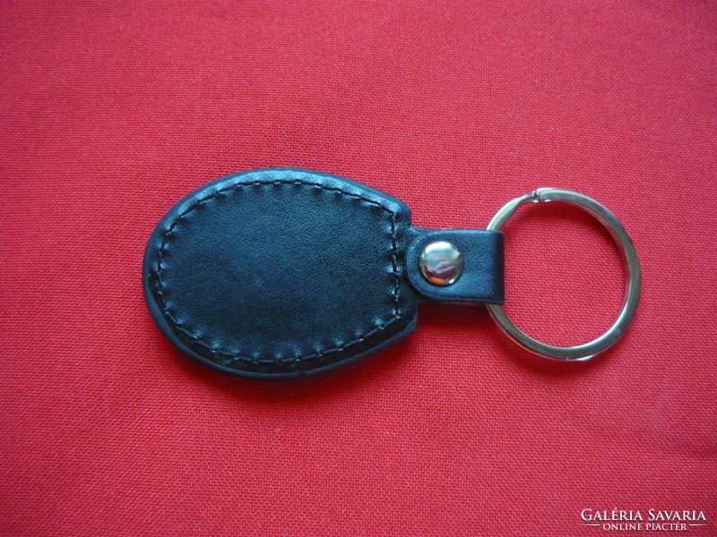Norton oval metal key ring on a leather base