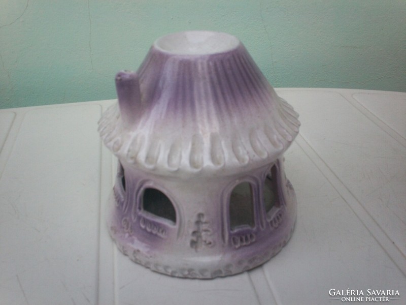 Pale purple candlestick round house with thatched roof