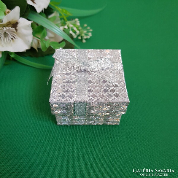 New, bow-decorated, shiny silver ring holder jewelry box