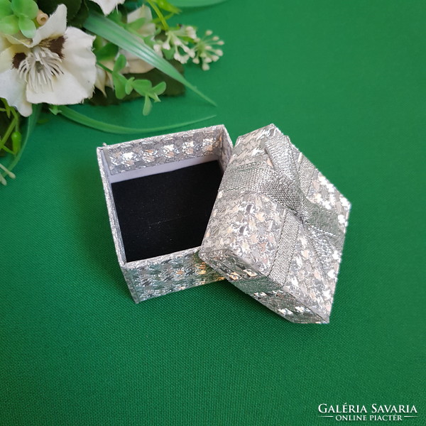 New, bow-decorated, shiny silver ring holder jewelry box