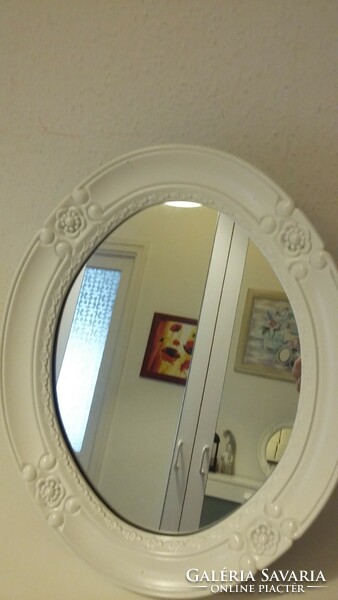 A small mirror with a white frame, very beautiful