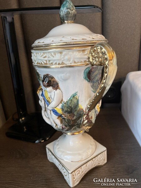 Italian goblet vase with a base, a lid, a handle, and a convex pattern.