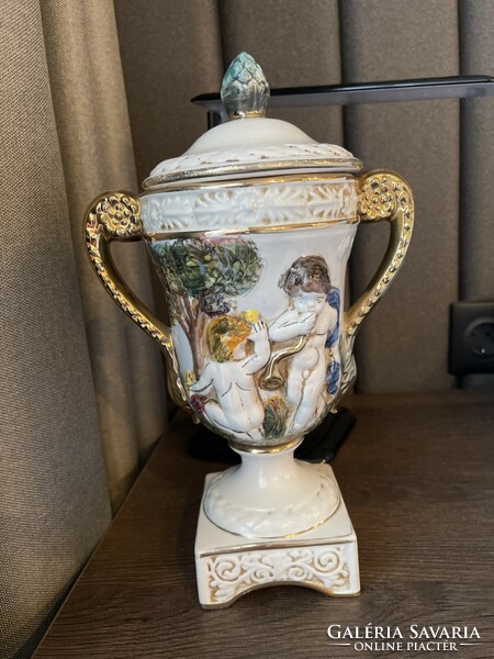 Italian goblet vase with a base, a lid, a handle, and a convex pattern.