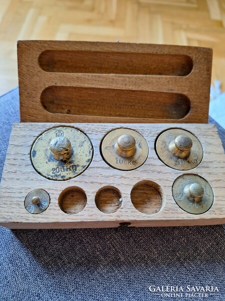 Old copper weights in a wooden box