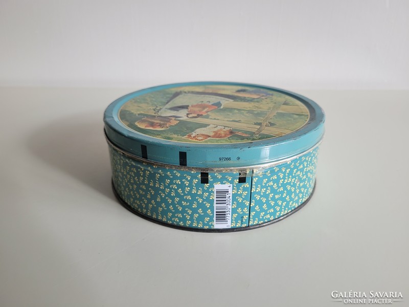 Retro metal biscuit box with a pattern of a little girl and a kitten