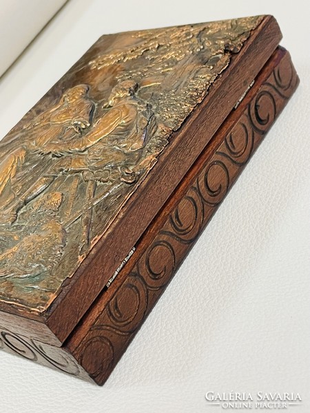 Old wooden box with copper relief pattern