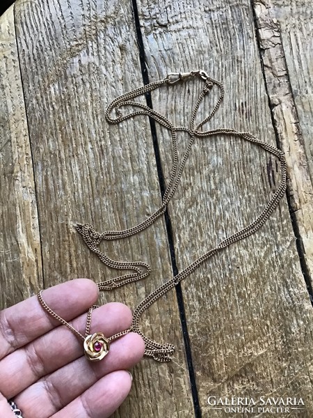 Old gilded pocket watch chain with small decoration.
