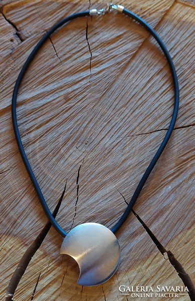 A very special silver moon pendant on a rubber chain