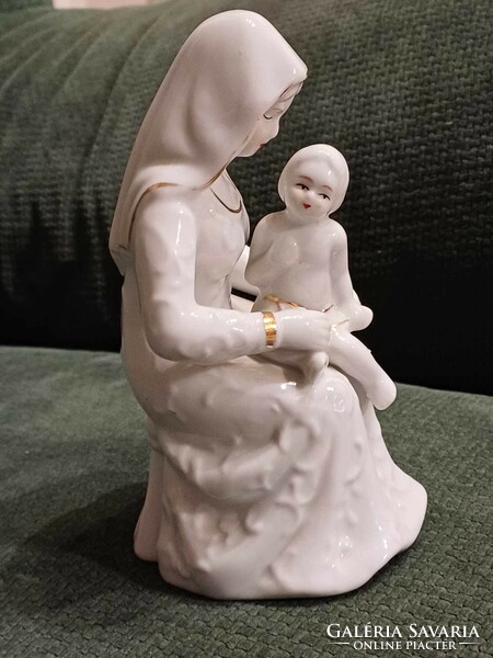 A charming porcelain statue of a mother with her child