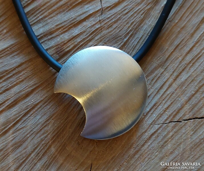 A very special silver moon pendant on a rubber chain