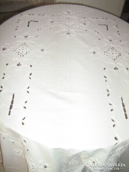 Elegant white tablecloth with a beautiful hand-crocheted border and a crochet insert