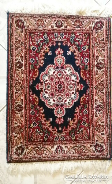 Tabriz in front of the door, a small hand-knotted, thick, stuffed wool carpet